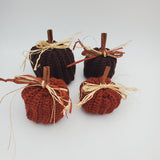 crochet pumpkins in a variety of fall colors with raffia and a cinnamon stick stem, fall table decorations, Thanksgiving decorations