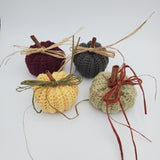crochet pumpkins in a variety of fall colors with raffia and a cinnamon stick stem, fall table decorations, Thanksgiving decorations