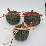 crochet pumpkins in a variety of fall colors with raffia and a cinnamon stick stem, fall table decorations, Thanksgiving decorations