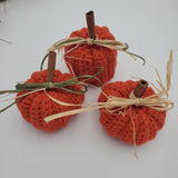 crochet pumpkins in a variety of fall colors with raffia and a cinnamon stick stem, fall table decorations, Thanksgiving decorations