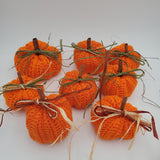 crochet pumpkins in a variety of fall colors with raffia and a cinnamon stick stem, fall table decorations, Thanksgiving decorations