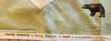 Wildlife sage green fabric panel with bear, moose, canoe, leaves, Canoe Country by Holly Taylor for Moda