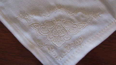 embroidered cloth napkins with a light lacy flower design